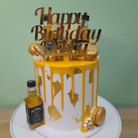 Tall Cake with Alcohol Bottles