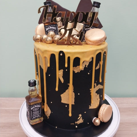 Tall Cake with Alcohol Bottles