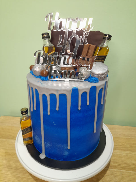 Tall Cake with Alcohol Bottles