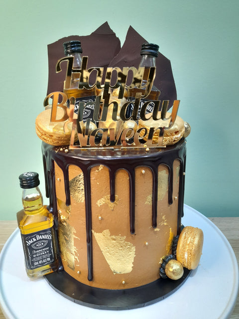 Tall Cake with Alcohol Bottles