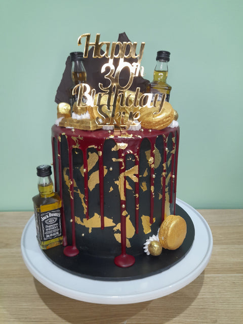 Tall Cake with Alcohol Bottles