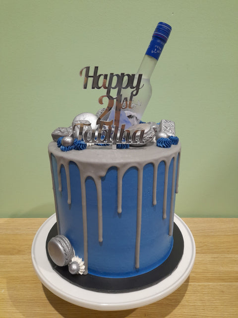 Tall Cake with Alcohol Bottles
