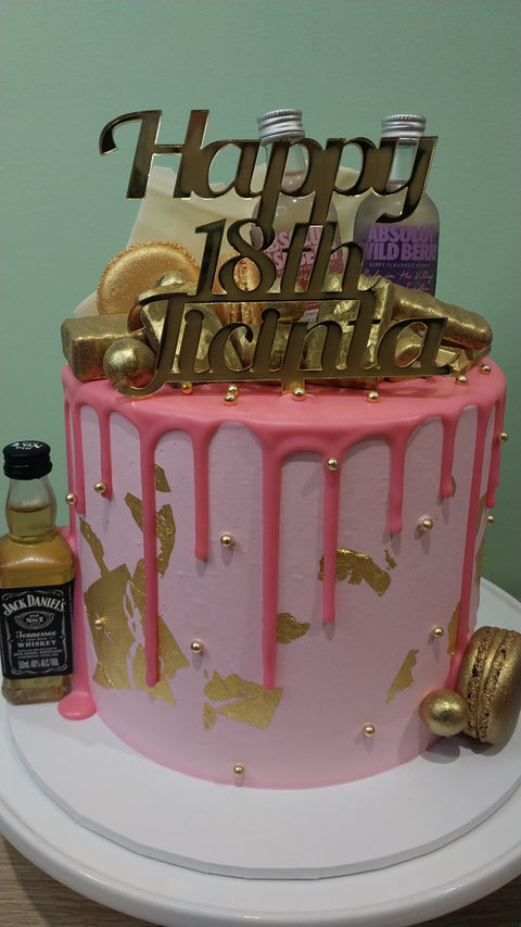 Tall Cake with Alcohol Bottles